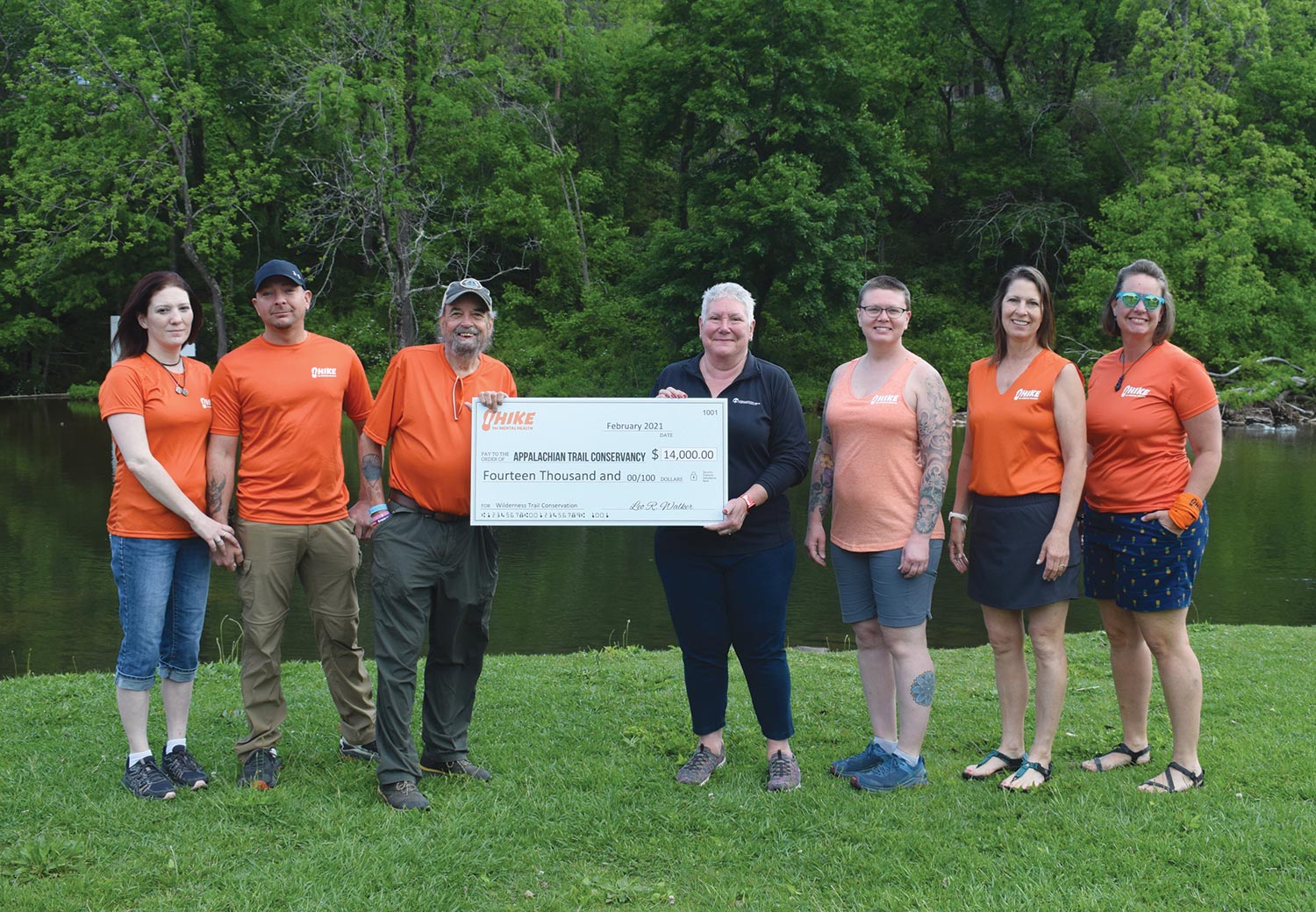 The organization Hike for Mental Health provides a generous donation to the Appalachian Trail Conservancy at Trail Days, received by Sandi Marra, ATC President and CEO (fourth from left)
