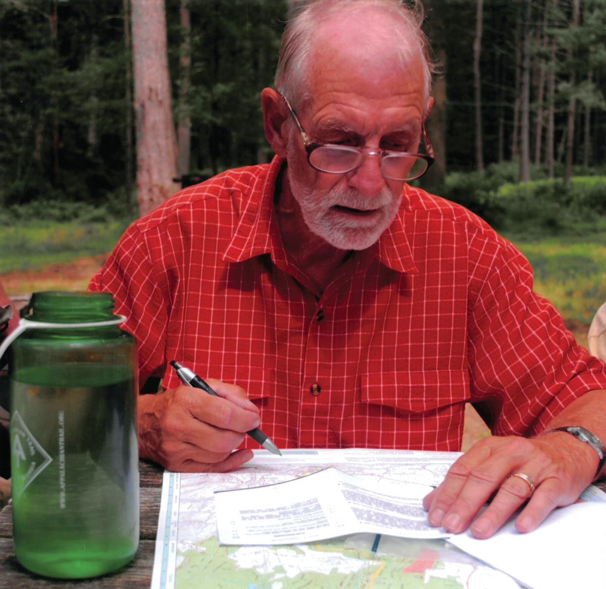 Larry reviews A.T. maps in preparation for an upcoming youth hike.