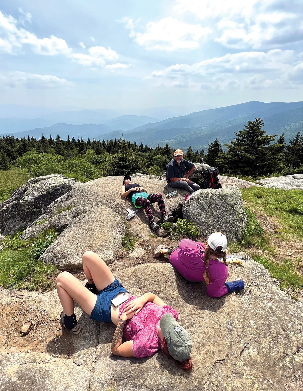 Sarah and her friends rest on a trail