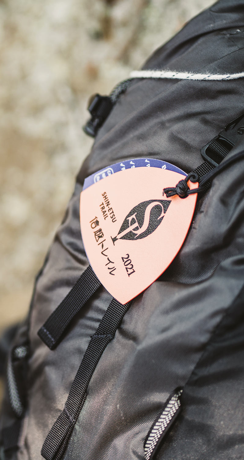 a hangtag for the Shinetsu Trail hangs from a backpack