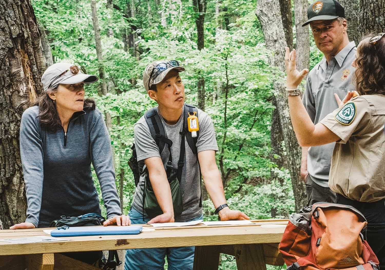 participants on the hike to McAfee Knob and the Shinetsu Trail Club representatives stand in discussion with an ATC ridge-runner