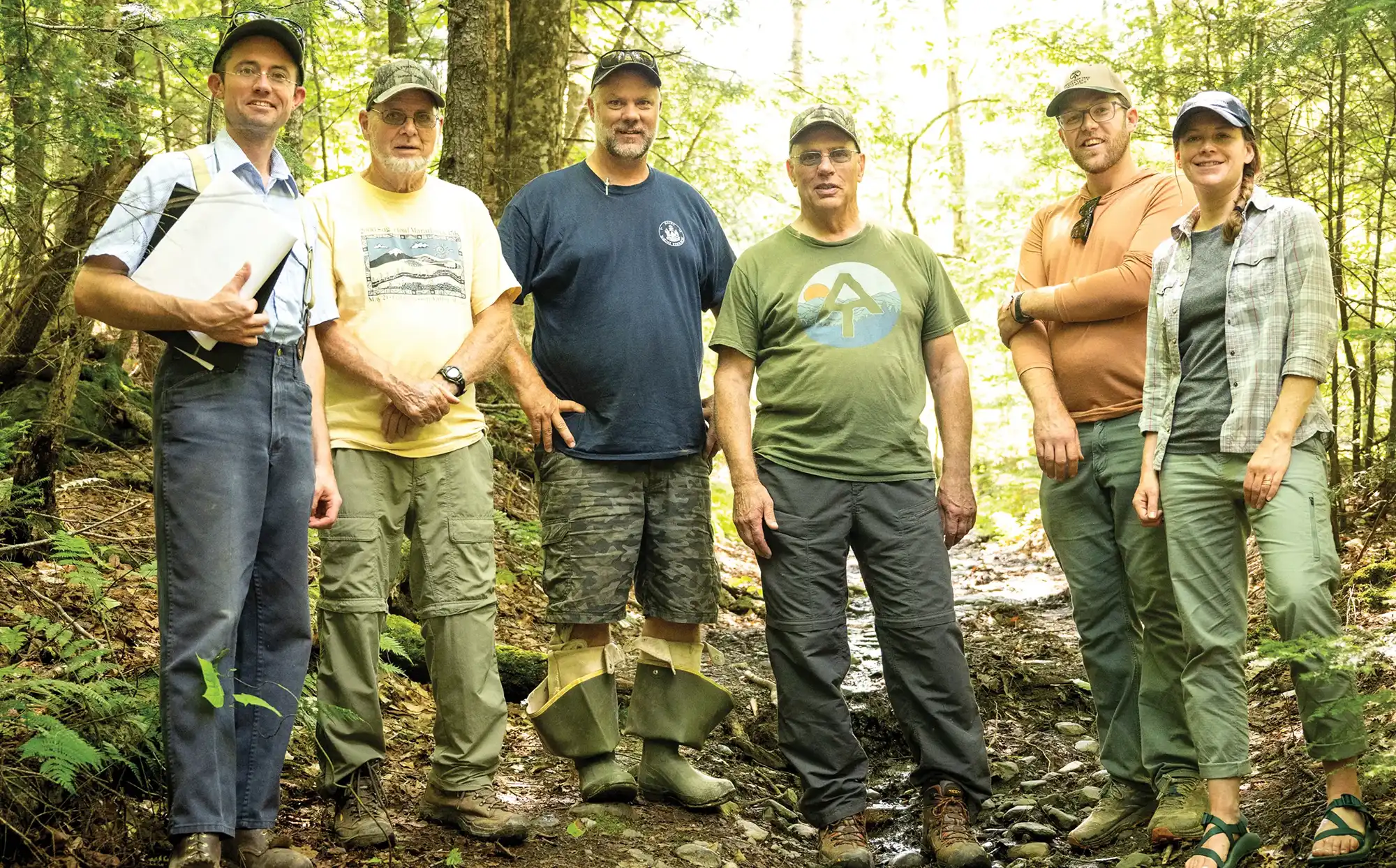 Group of six partners from the Appalachian Mountain Club and the Maine Department of Marine Resources standing on the trail