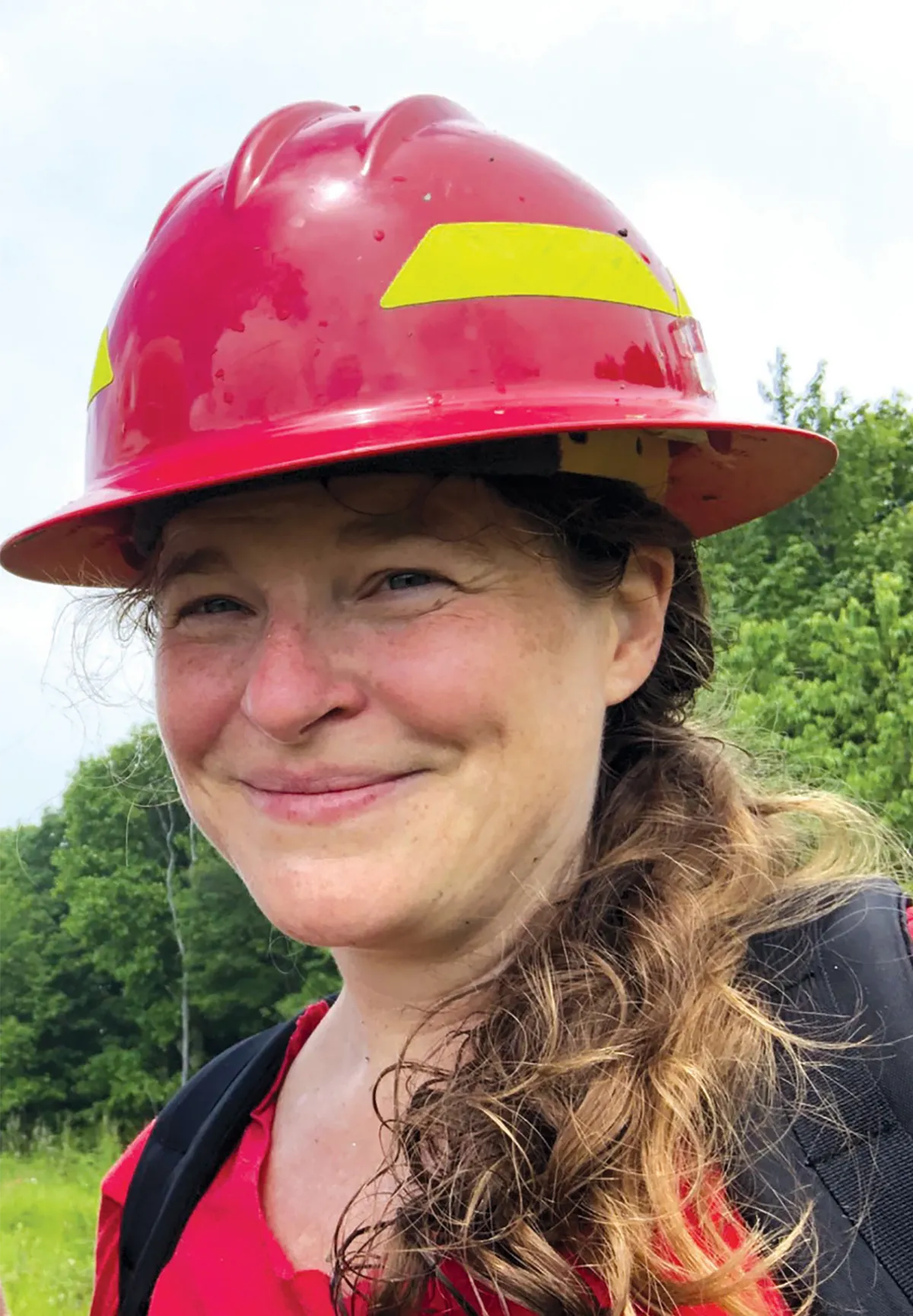 Leanna Joyner smiling in a red hard hat