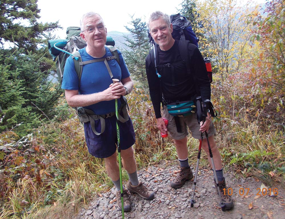 Don DeArmon and Ted Gregory standing next to each other while wearing hiking gear posing for a picture