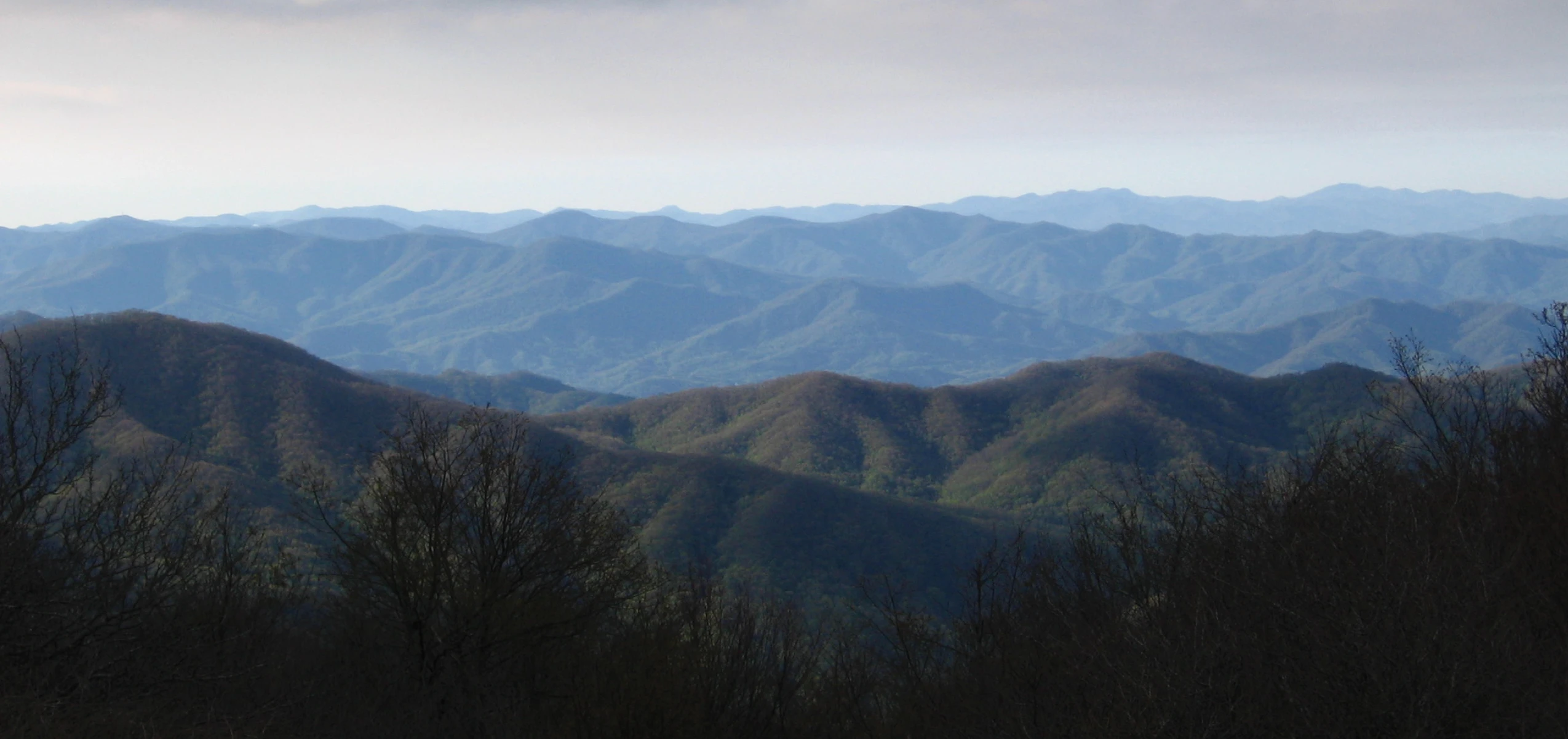 Mountain landscape with layers of hills and mountains extending into the distance.