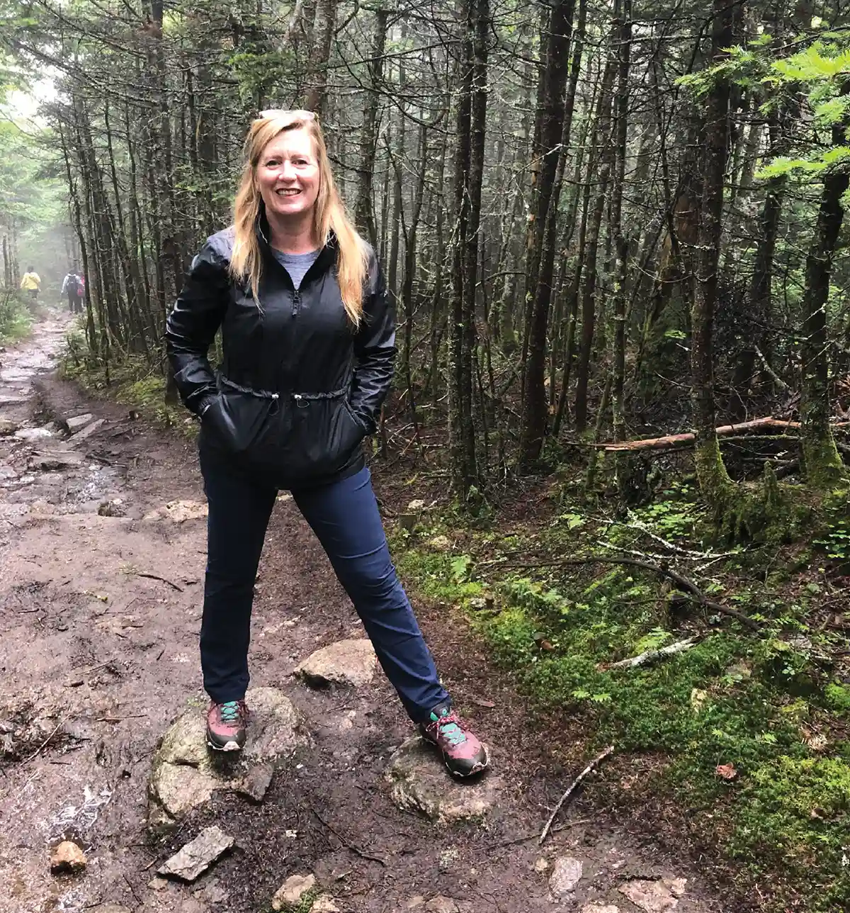Jeri Ward posing for a photo on a hiking trail in the Green Mountains