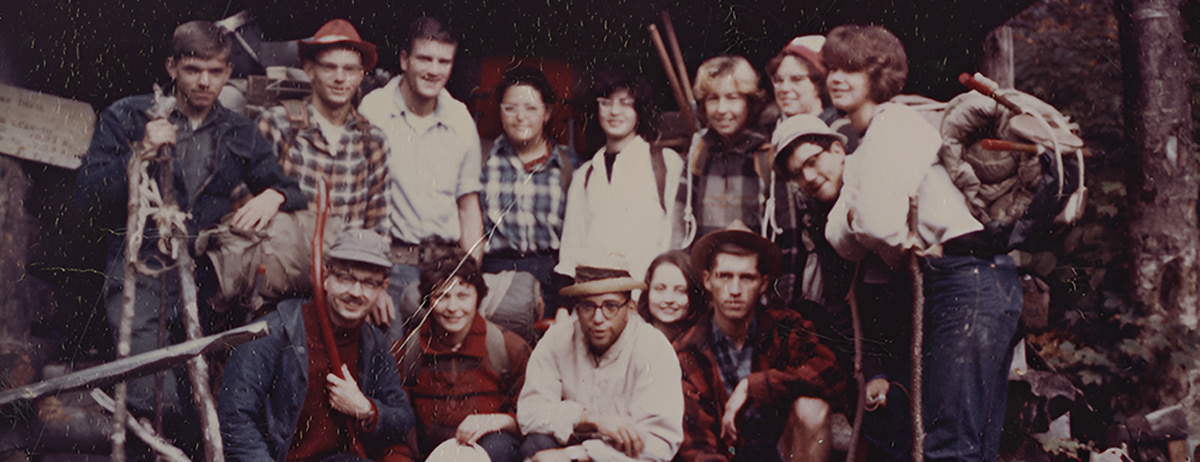 worn undated group photo of a previous outdoor recreation club with each member dressed and packed for hiking