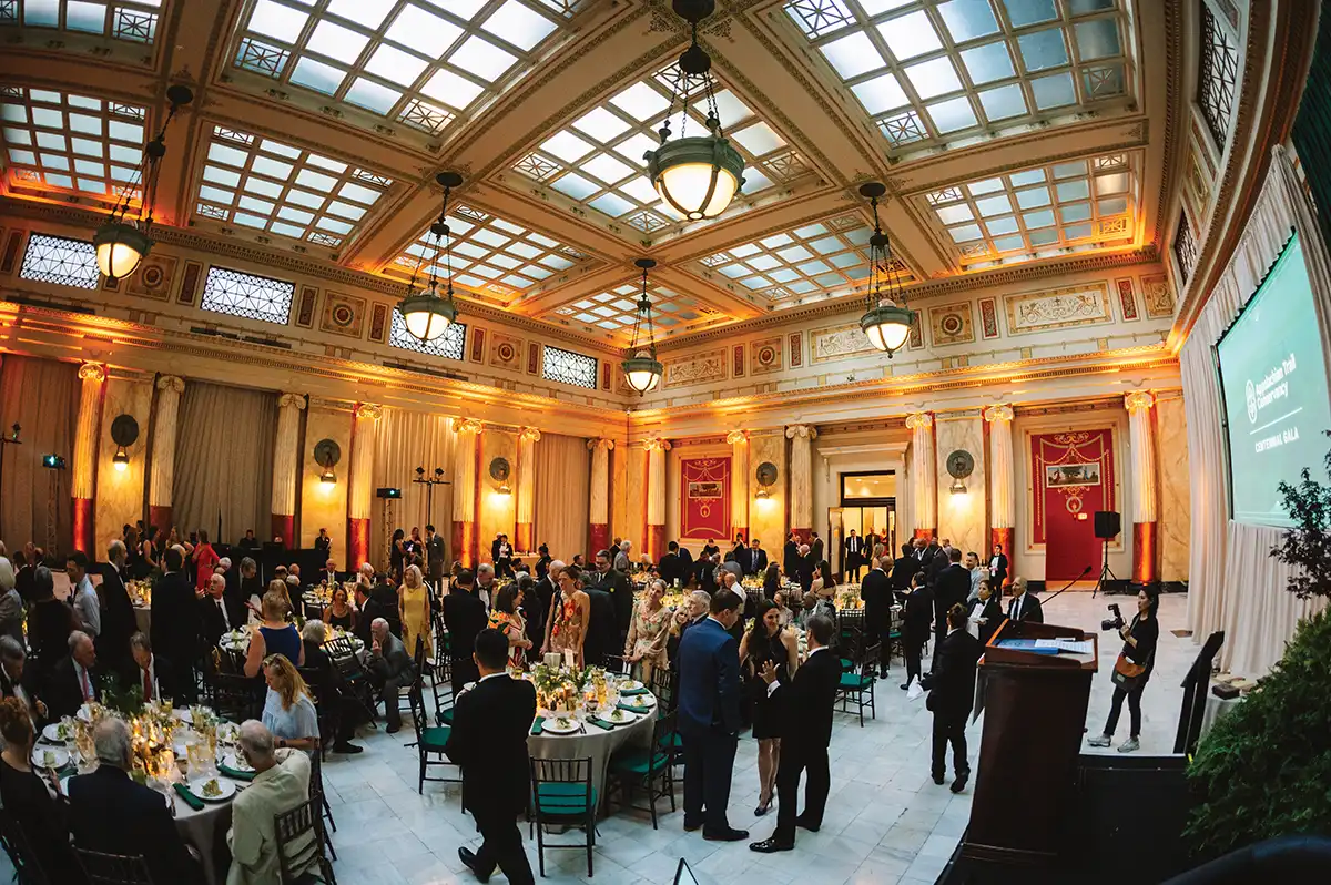 Grand ballroom filled with people attending a formal event.