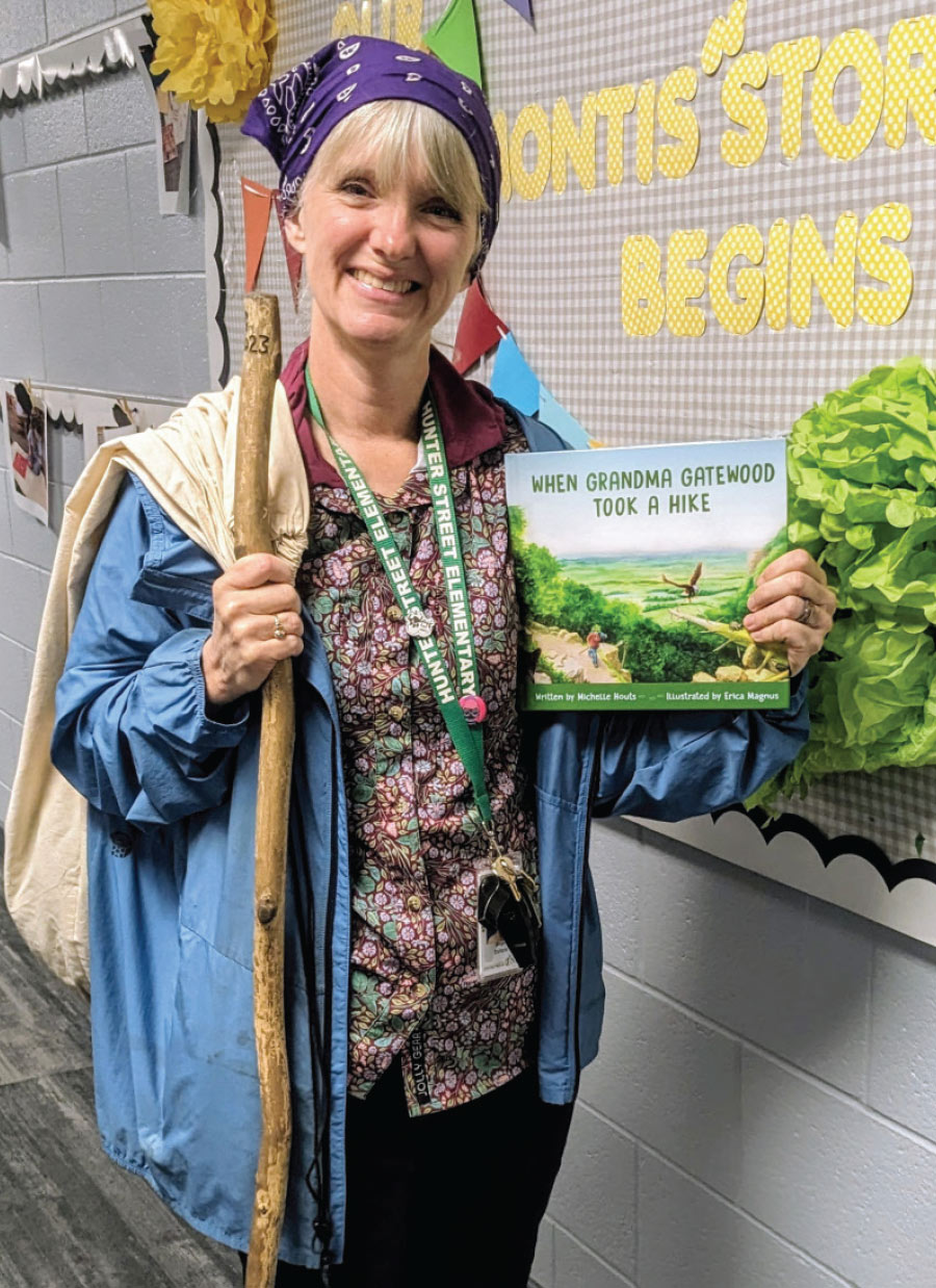 Ginger DeHaan dressed as Grandma Gatewood while holding book
