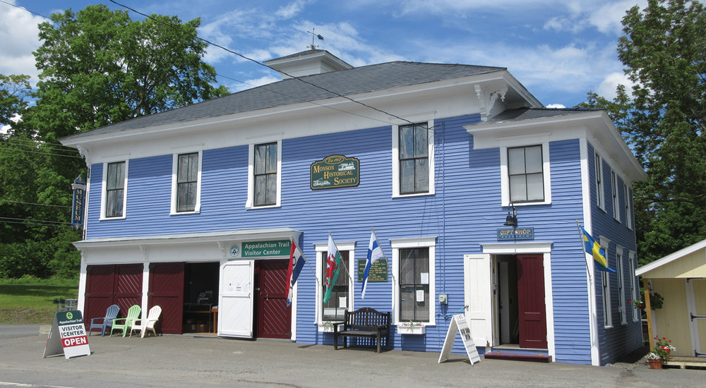 A bright blue, historic two-story building that houses both the Appalachian Trail Visitor Center and a local historical society/museum.