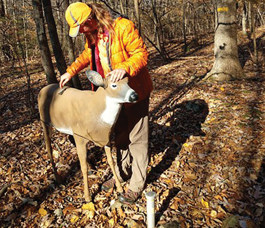 man with deer decoy