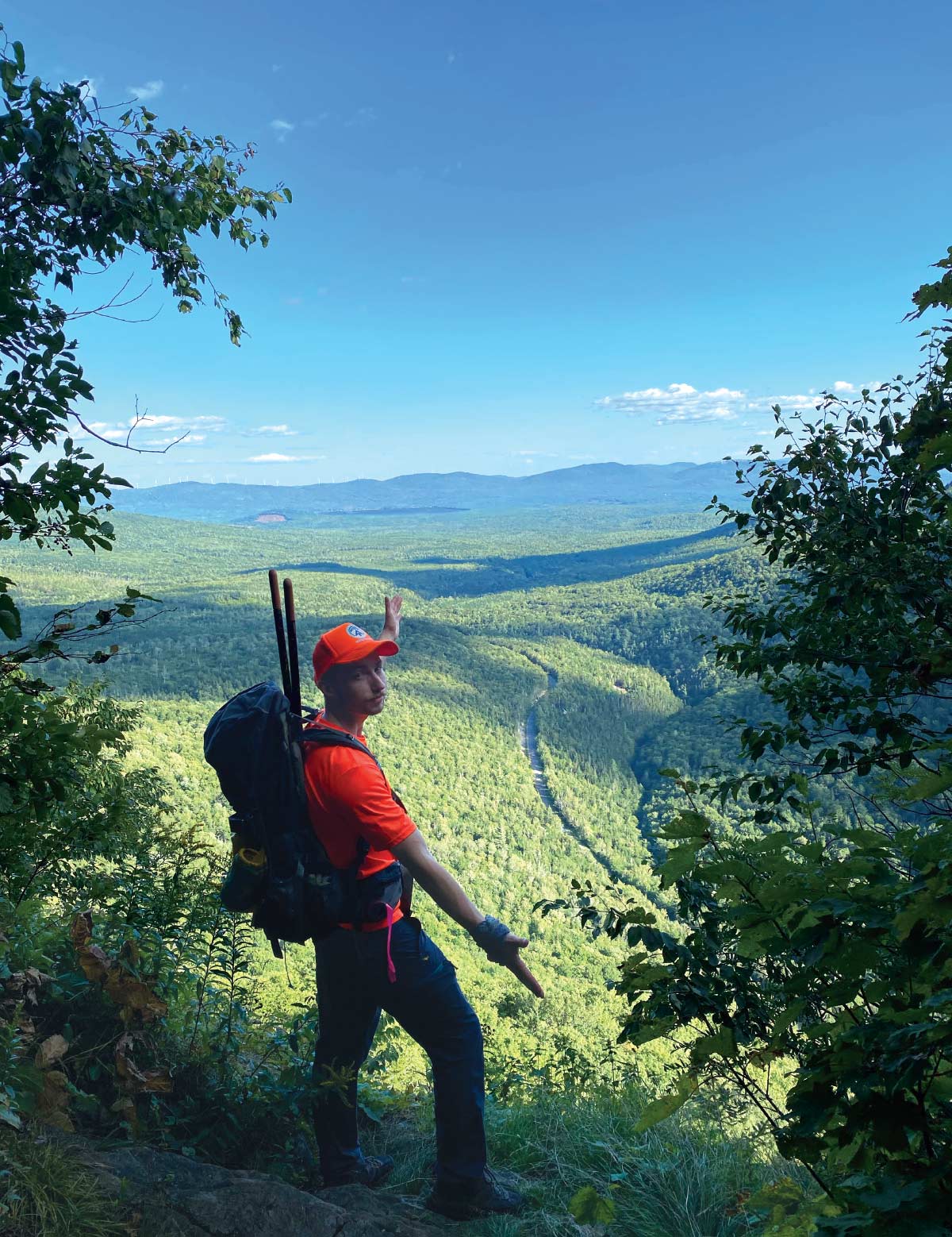 Jonah Wusteney during hike with view of hilly landscape