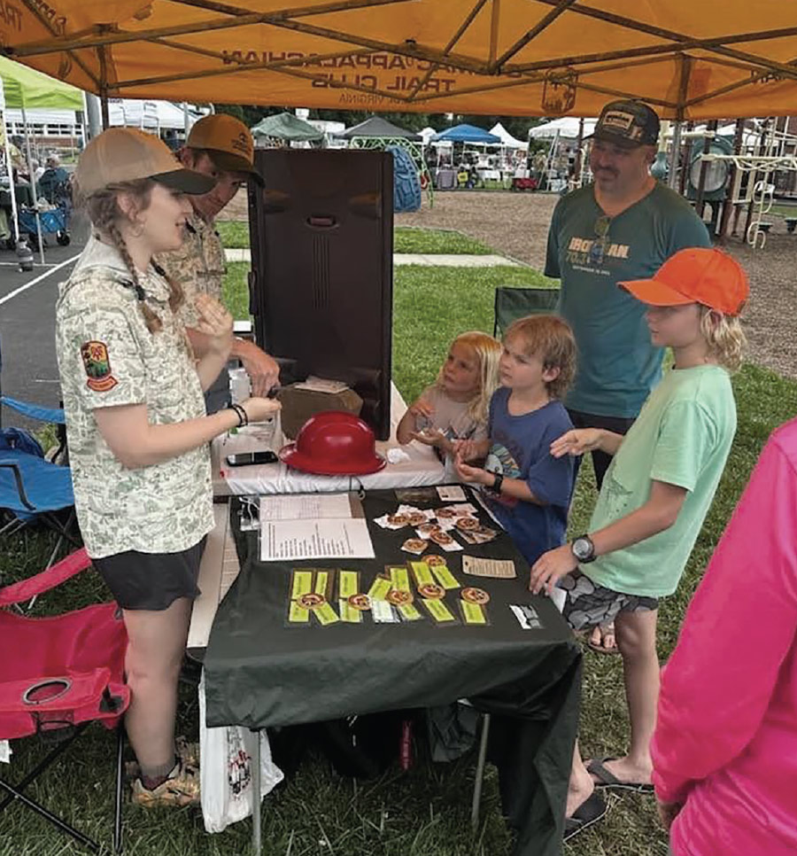 staff speaking to young Trail enthusiasts